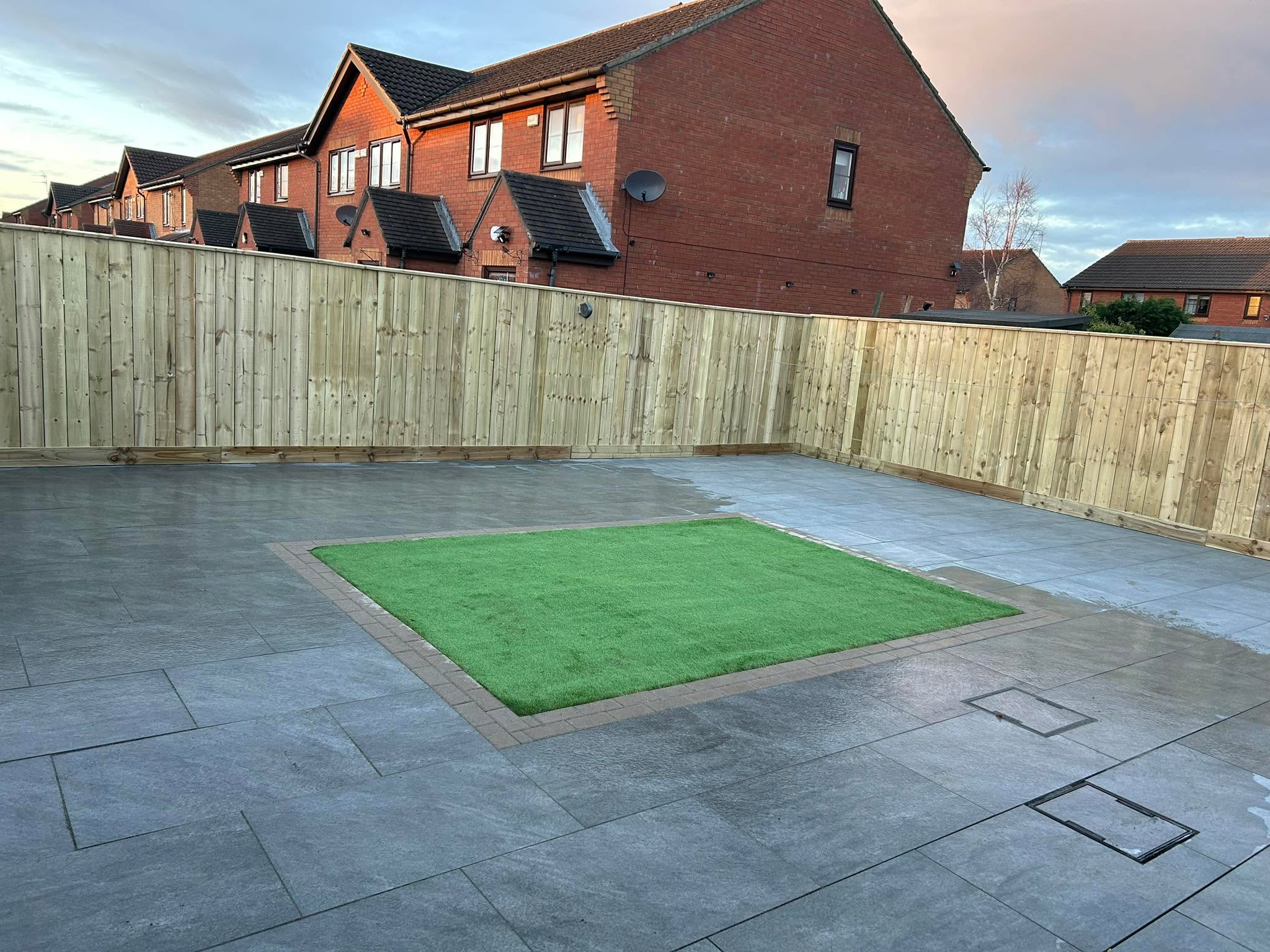 Porcelain patio with artificial grass inset and new fencing — MDD Building Services, Gateshead